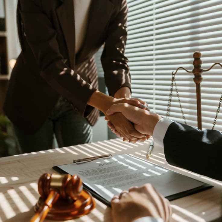 Professional handshake over legal documents